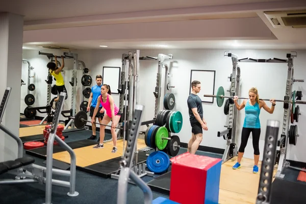 Fit people working out in weights room — Stock Photo, Image