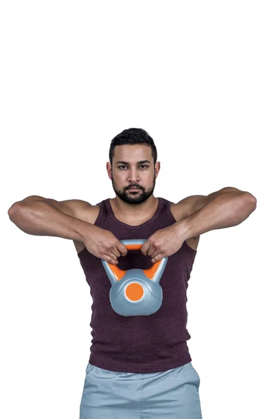 Homem sério levantando um kettlebell — Fotografia de Stock