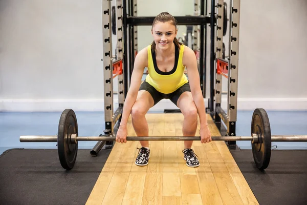 Woman  lifting a barbell and weights — Stock Photo, Image