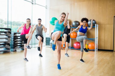 Fitness class exercising in the studio clipart
