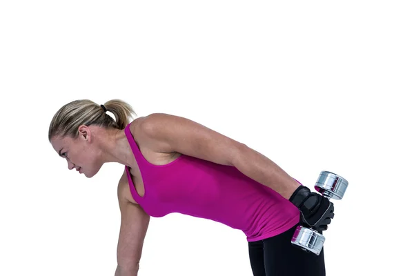 Muscular woman exercising with dumbbell — Stock Photo, Image