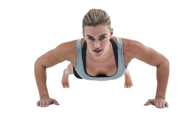 Muscular woman doing push-ups — Stock Photo, Image