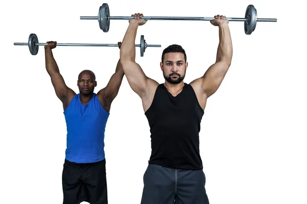 Hombre levantando barras con entrenador — Foto de Stock