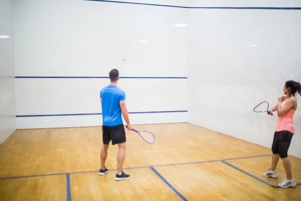 Couple play some squash together — Stock Photo, Image