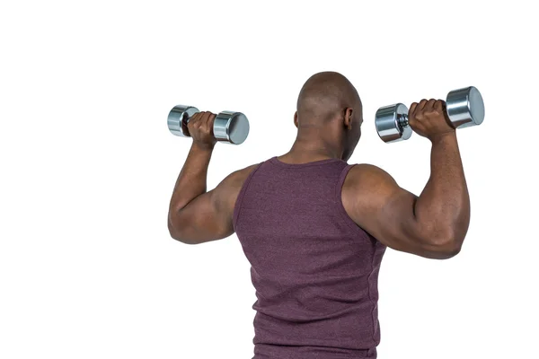 Hombre en forma haciendo ejercicio con pesas —  Fotos de Stock