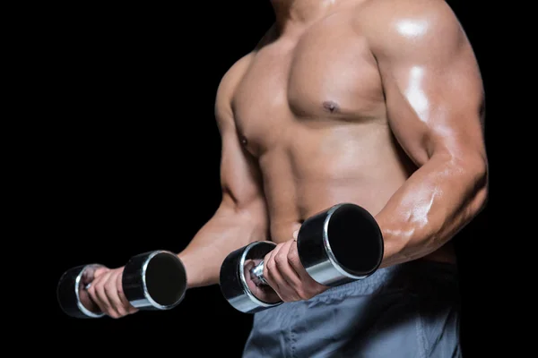 Mid section of a bodybuilder with dumbbells — Stock Photo, Image