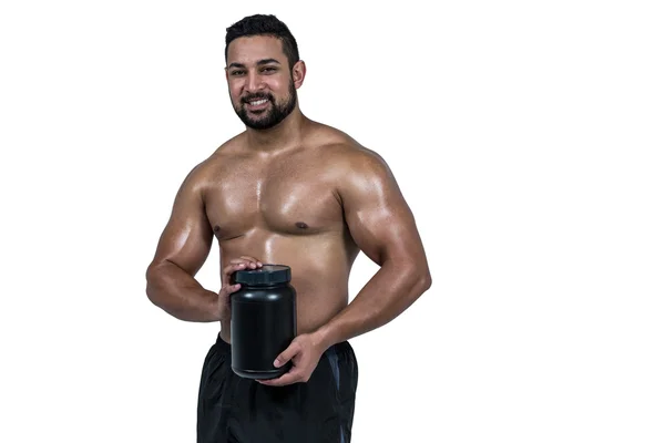 Muskulöser Mann mit Eiweißpulver — Stockfoto
