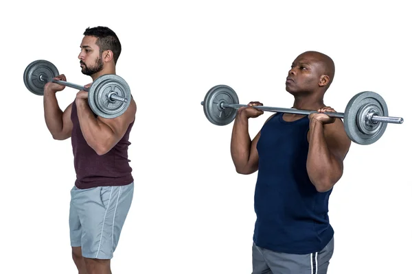 Dois homens musculosos levantando sinos — Fotografia de Stock