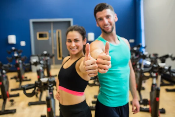 Focused couple giving thumbs up — Stock Photo, Image
