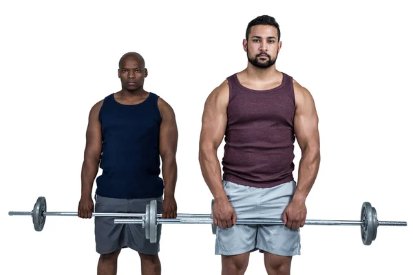 Hombre levantando barras con entrenador — Foto de Stock