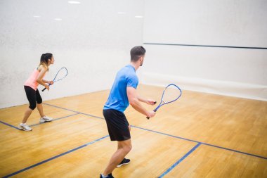 Couple enjoying a game of squash clipart