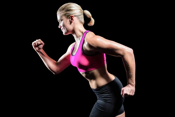 Muscular woman running in sportswear — Stock Photo, Image