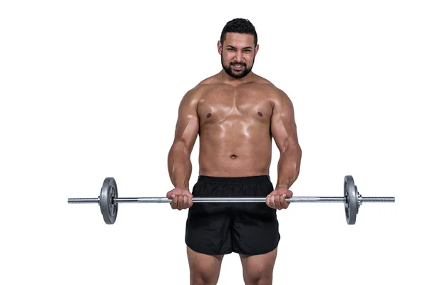 Homem muscular levantando pesado barbell — Fotografia de Stock