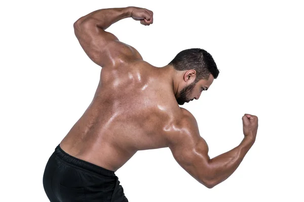 Muscular man flexing for camera — Stock Photo, Image