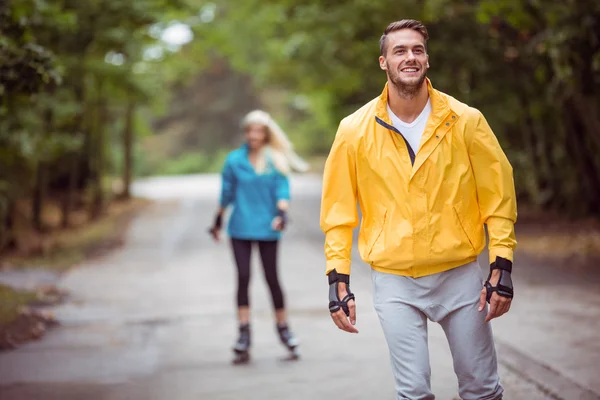 Happy couple roller blading together — Stock Photo, Image