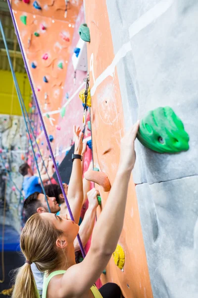 Fit people rock climbing indoors — Stock Photo, Image