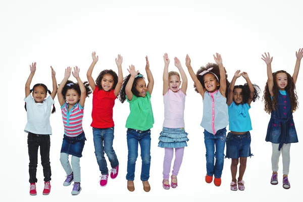 Line of girls standing with arms raised — Stock Photo, Image