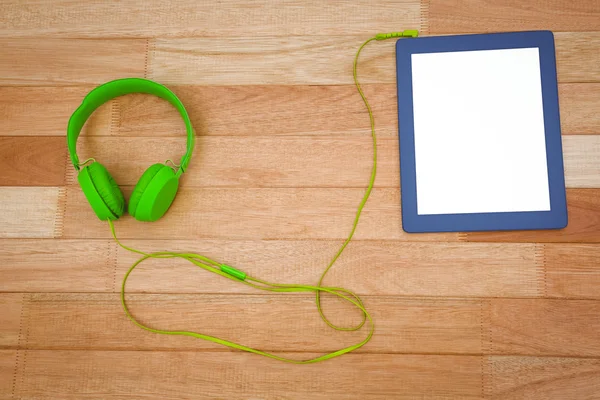 Auriculares verdes con una tableta azul — Foto de Stock