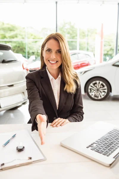 Smiling saleswoman ready to shake hand — Stock Photo, Image