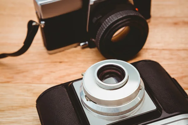 Two old cameras on wood desk — Stock Photo, Image