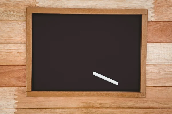 Big blackboard against wood plank — Stock Photo, Image