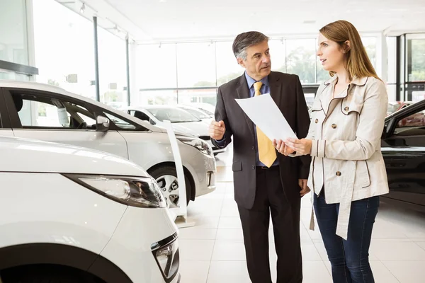 Vendeur montrant une voiture à un client — Photo