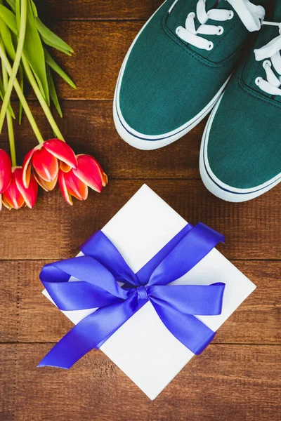 Sneakers and blue gift — Stock Photo, Image