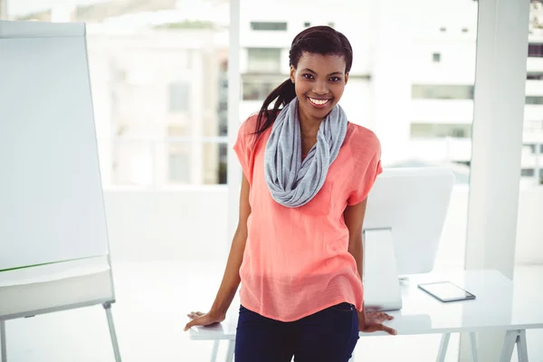 Smiling creative businesswoman by her desk — Stock Photo, Image