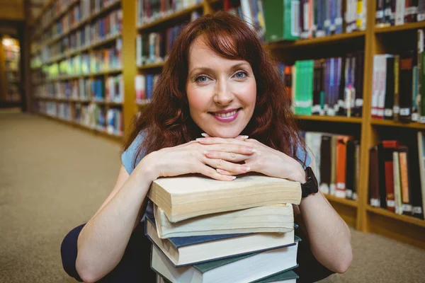 Mature student smiling in library — Stock Photo, Image