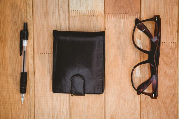 Glasses and wallet on wood desk — Stock Photo, Image