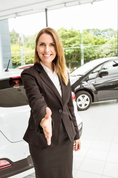 Smiling saleswoman ready to shake hand — Stock Photo, Image