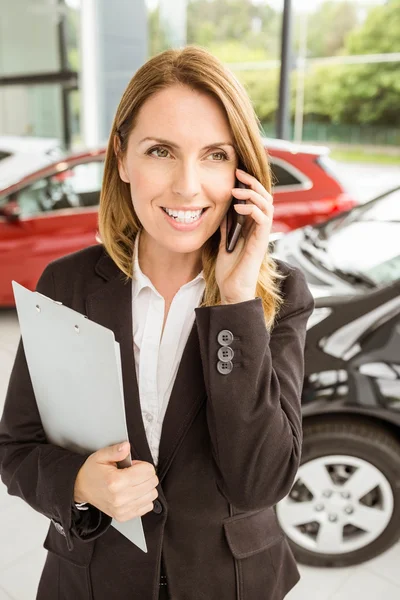 Smiling saleswoman having a phone call — Stock Photo, Image