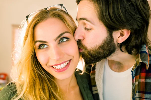 Hipster kissing his pretty colleague — Stock Photo, Image