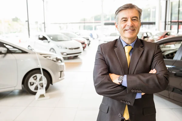 Un hombre de negocios sonriente con los brazos cruzados — Foto de Stock