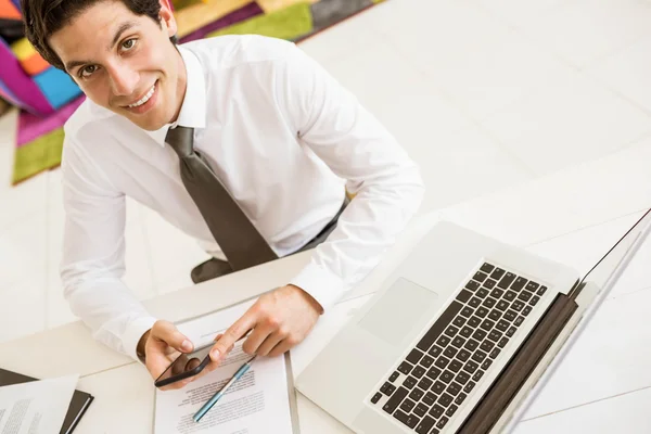 Smiling salesman having a phone call — Stock Photo, Image