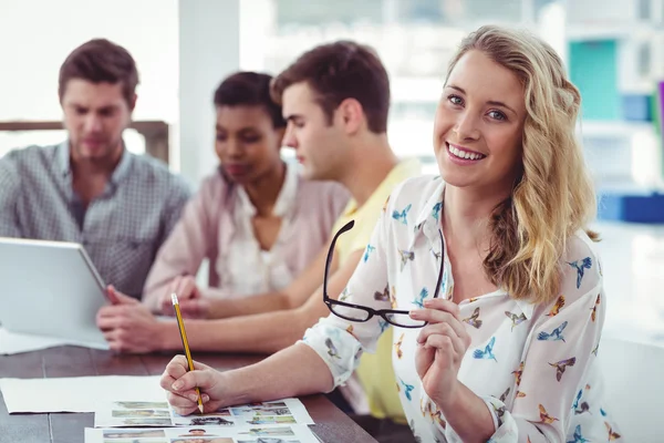 Creative business team working on a laptop together — Stock Photo, Image