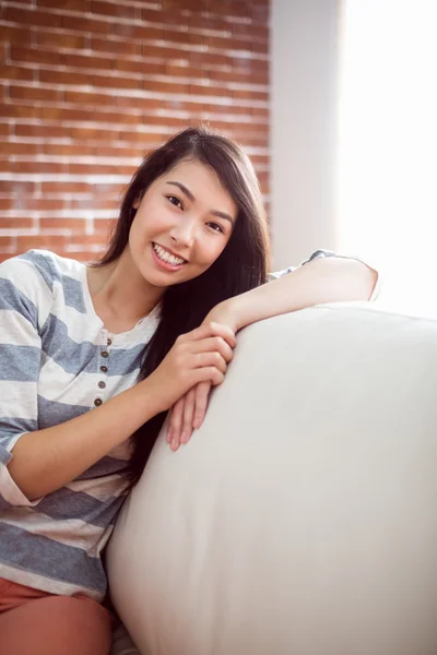 Sorrindo asiático mulher no sofá — Fotografia de Stock