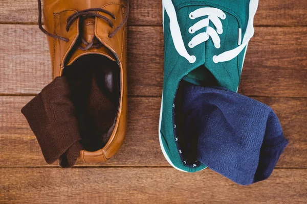 Two different shoes on wood plank — Stock Photo, Image