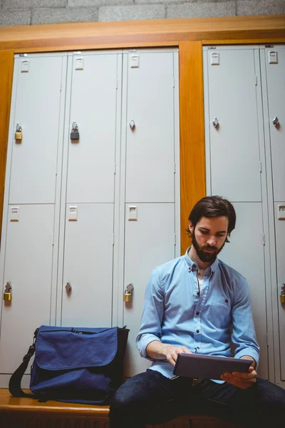 Hipster student pomocí tabletu v chodbě — Stock fotografie