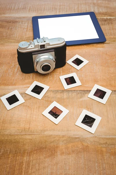 Old camera and a blue tablet — Stock Photo, Image