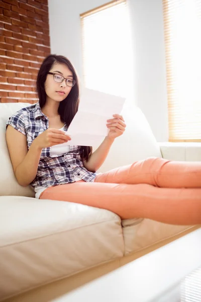 Asiatische Frau auf der Couch Brief lesen — Stockfoto