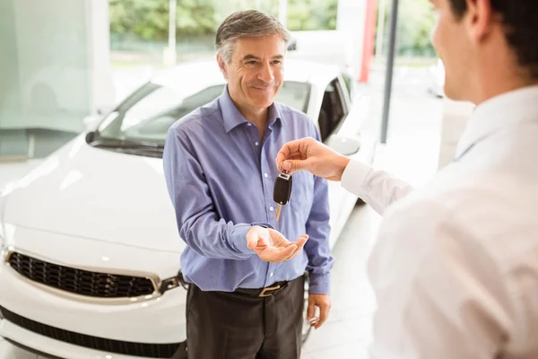 Uomo d'affari che dà la chiave dell'automobile ad un cliente — Foto Stock