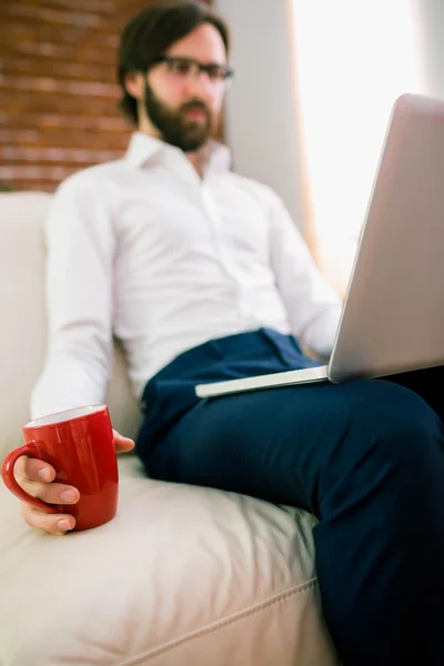 Affärsman med laptop i soffan — Stockfoto