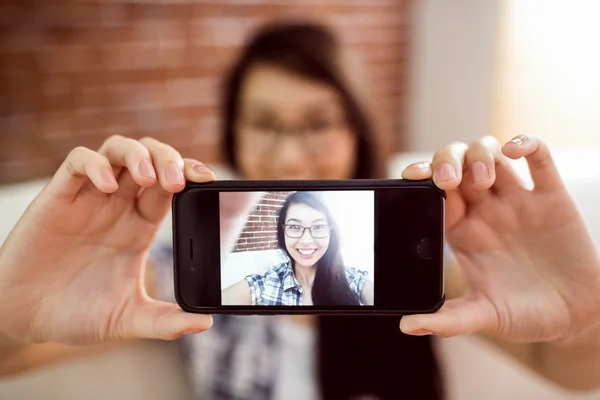 Asian woman on the couch taking selfie — Stock Photo, Image