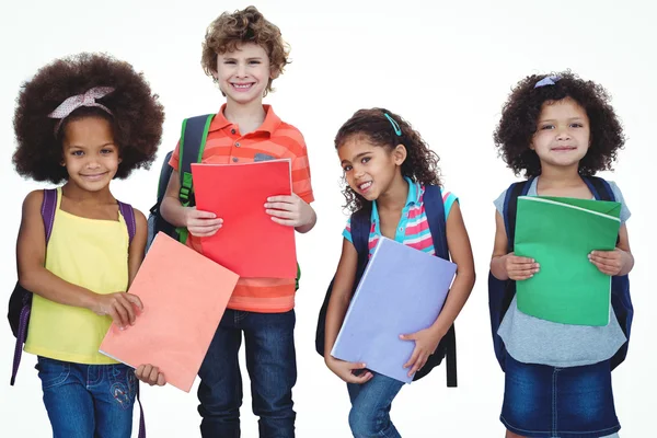 Fila de niños de pie junto con bolsas escolares —  Fotos de Stock