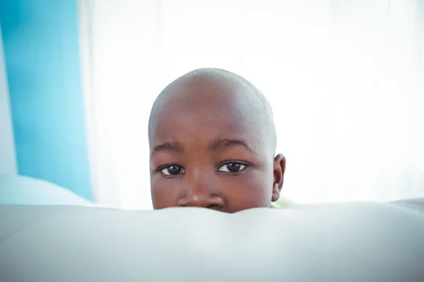 Happy kid looking from the back of the couch — Stock Photo, Image