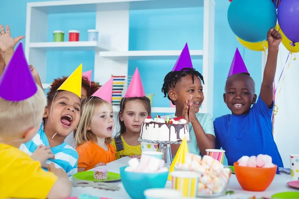 Excited kids enjoying a birthday party Royalty Free Stock Images