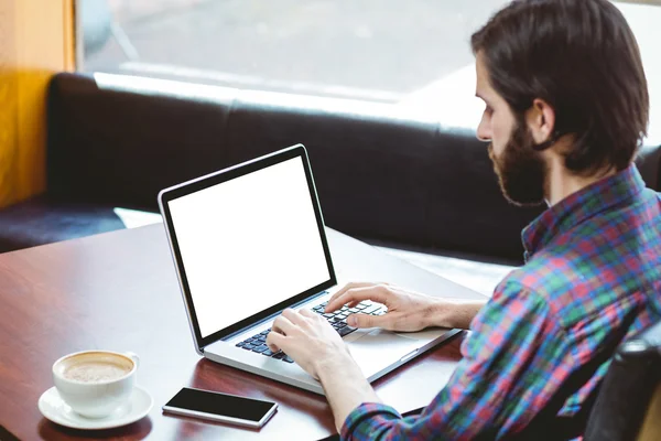 Hipster student using laptop in canteen — Stock Photo, Image