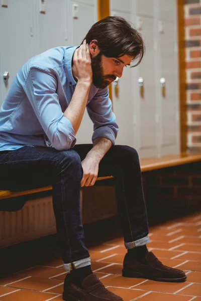 Hipster student feeling sad in hallway — Stock Photo, Image