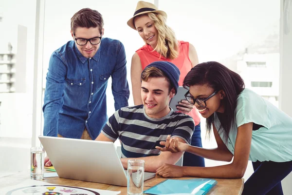 Creative business team working hard together on laptop — Stock Photo, Image